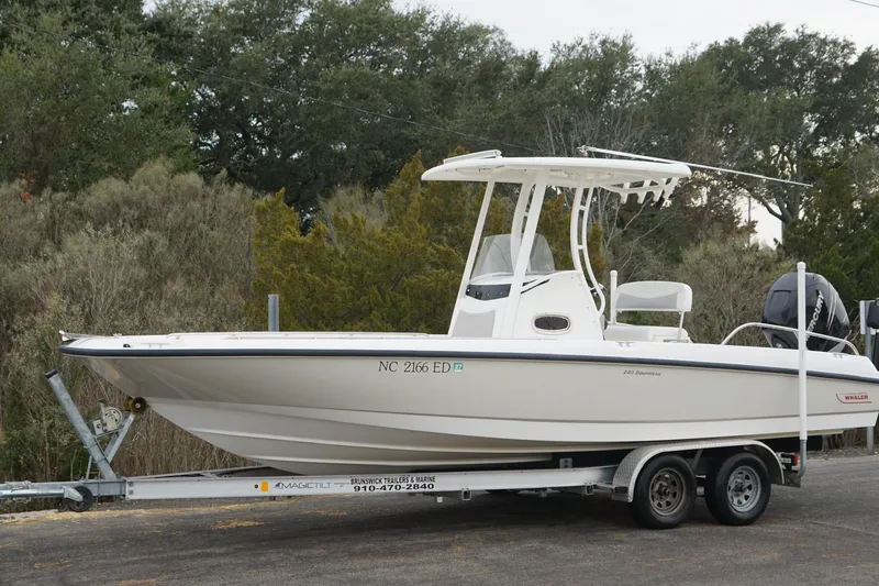 Slide: The Image of 2016 Boston Whaler 240 Dauntless boat on trailer, parked outdoors. - 15