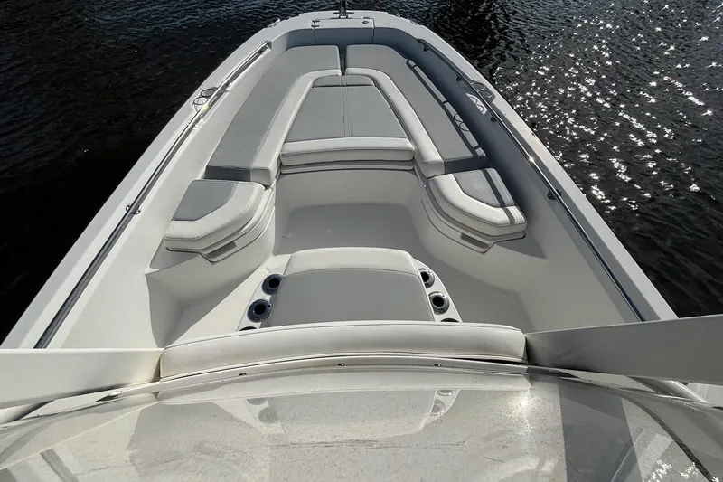 Slide: The Image of 2016 Boston Whaler 240 Dauntless boat interior with cushioned seating and cup holders. - 25