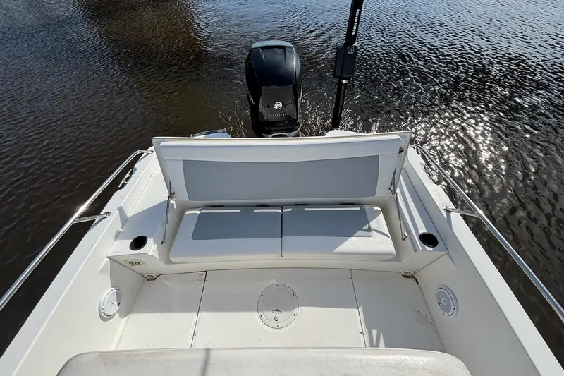 Slide: The Image of 2016 Boston Whaler 240 Dauntless boat with seating and outboard motor on water. - 32