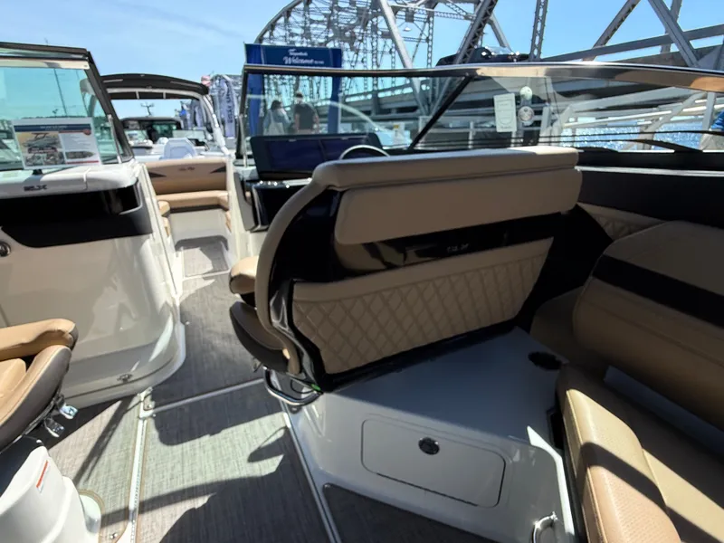 Slide: The Image of The image shows the interior of a Sea Ray SLX 280 boat with beige seats and a bridge view. - 32