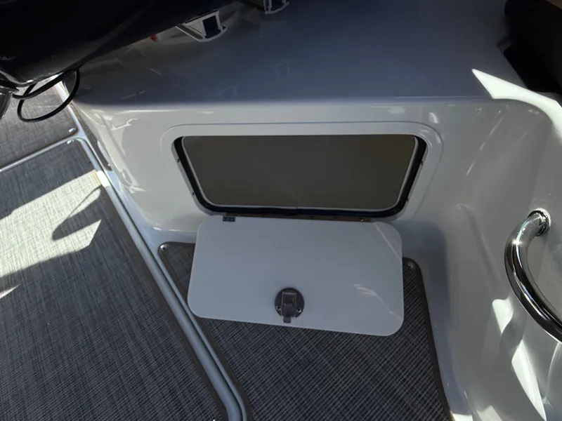 Slide: The Image of An open storage compartment on a 2026 Sea Ray SLX 280 boat. - 31