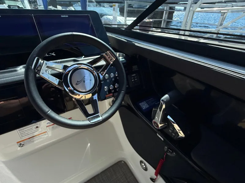 Slide: The Image of The image shows the helm of a Sea Ray SLX 280 boat with modern controls. - 36