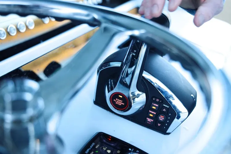 Slide: The Image of Close-up of Freeman 47 boat controls, featuring throttle and start button, 2022 model. - 10