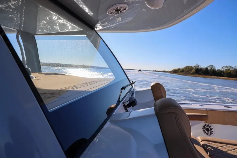 Slide: The Image of 2022 Freeman 47 boat cruising on a sunny day, showcasing sleek design and luxury seating. - 11