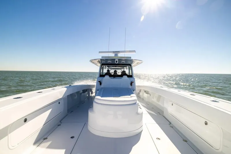 Slide: The Image of 2022 Freeman 47 boat cruising on open water under clear blue sky. - 14