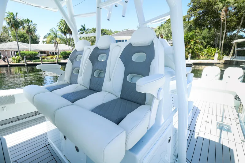 Slide: The Image of Luxury Freeman 47 boat, 2022 model, with spacious deck and seating, docked by a serene waterfront. - 16