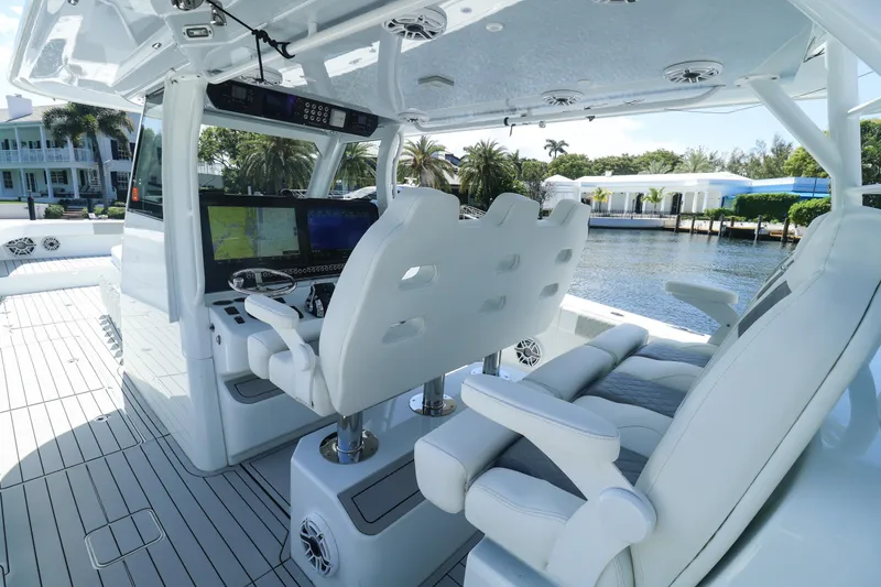 Slide: The Image of Interior view of 2022 Freeman 47 boat with navigation screens and waterfront scenery. - 19
