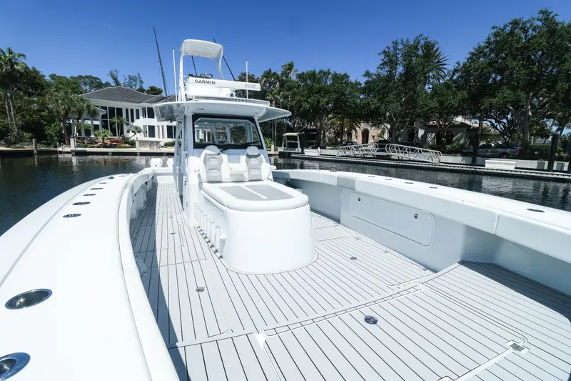 Slide: The Image of Luxurious seating on a 2022 Freeman 47 boat, docked by a scenic waterfront. - 21