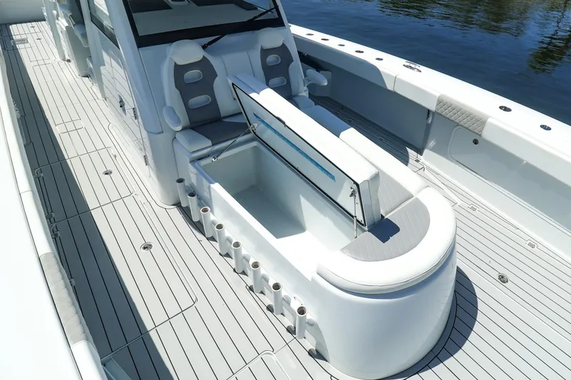 Slide: The Image of 2022 Freeman 47 boat with spacious deck, docked near waterfront homes and lush greenery. - 28