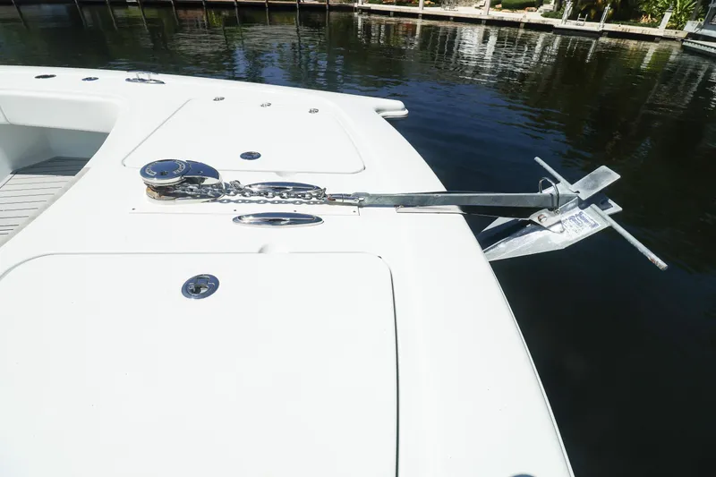 Slide: The Image of 2022 Freeman 47 boat docked by waterfront homes under clear blue sky. - 29