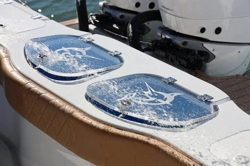 Slide: The Image of 2022 Freeman 47 boat with water splashing on livewell lids, featuring a marlin design. - 3