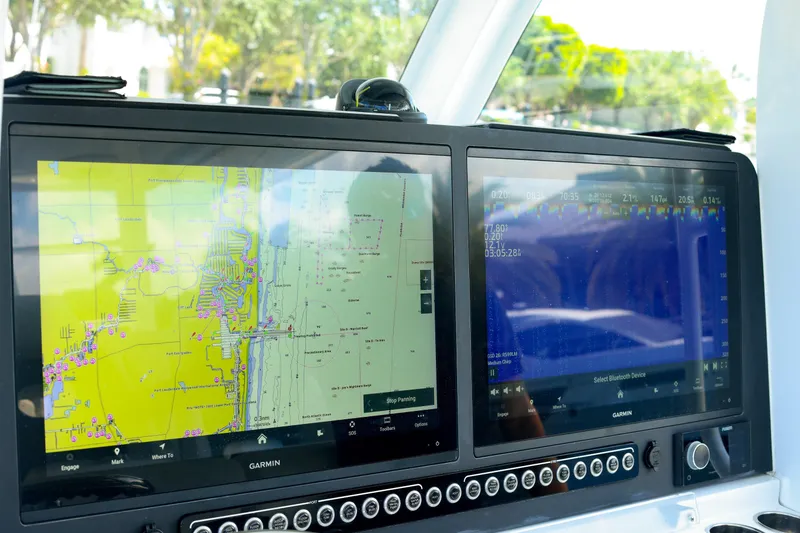 Slide: The Image of Storage compartment in a 2022 Freeman 47 boat, featuring a secured white container. - 34