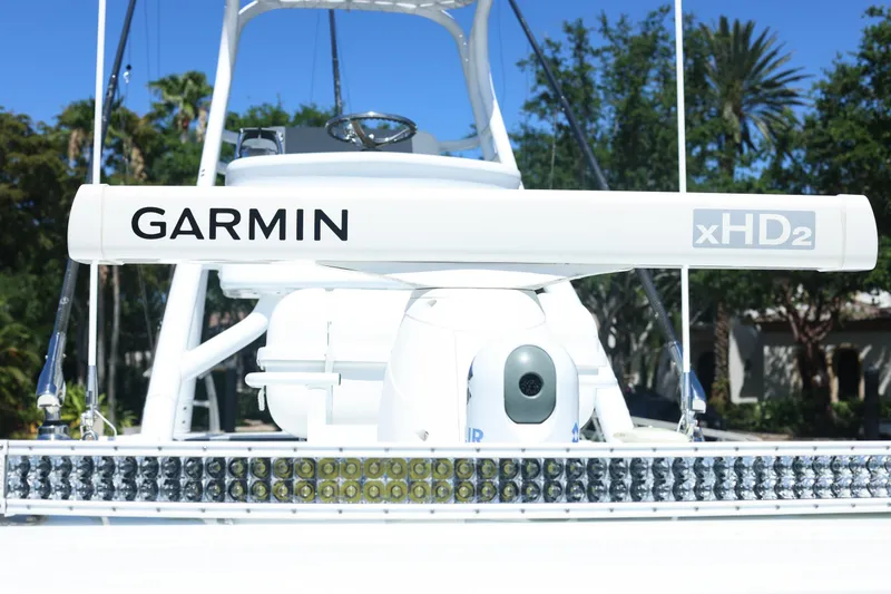 Slide: The Image of Twin Mercury FourStroke outboard engines on a 2022 Freeman 47 boat, docked on water. - 43
