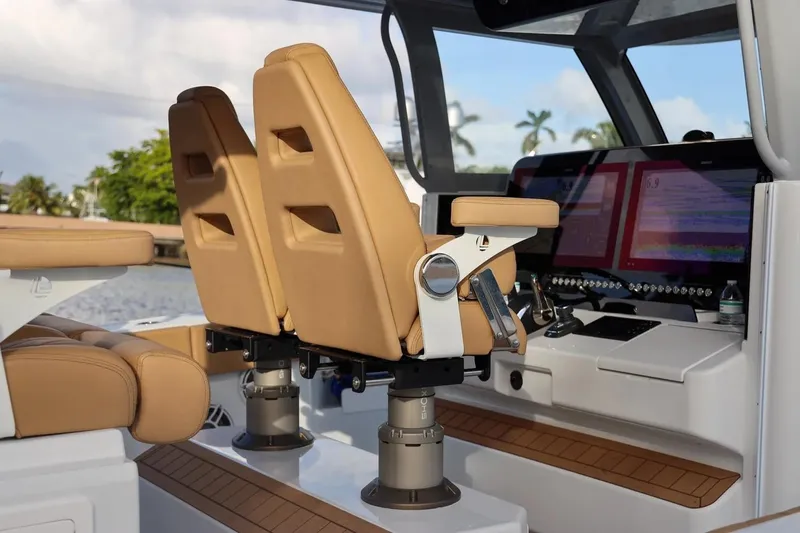 Slide: The Image of Luxury Freeman 47 boat interior with tan seats and advanced navigation system, 2022 model. - 7