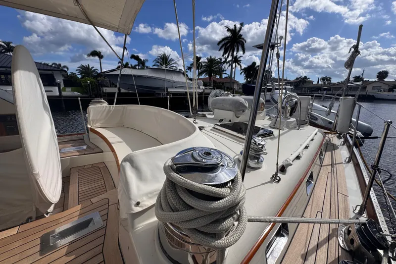 Slide: The Image of 1989 Little Harbor Sloop 58' yacht deck with ropes and seating, under a sunny sky. - 11