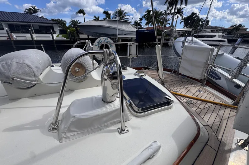 Slide: The Image of 1989 Little Harbor Sloop 58' yacht deck with polished fittings and marina backdrop. - 14