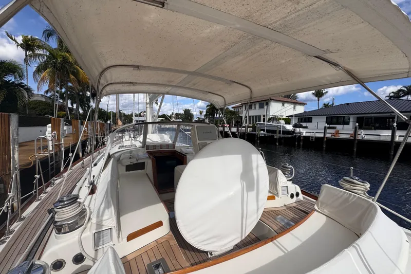 Slide: The Image of 1989 Little Harbor Sloop 58' yacht docked, featuring spacious deck and canopy. - 19