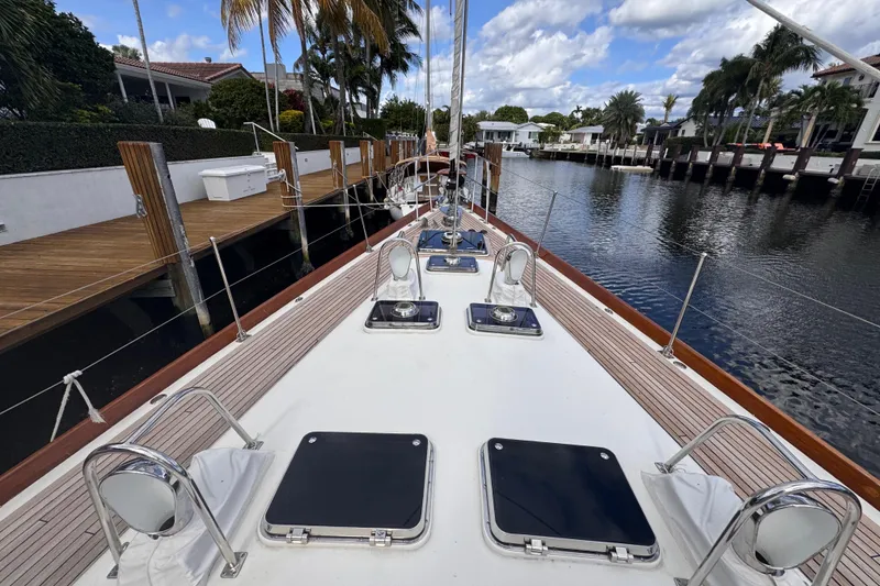 Slide: The Image of 1989 Little Harbor Sloop 58' docked, showcasing sleek deck design and waterfront view. - 32