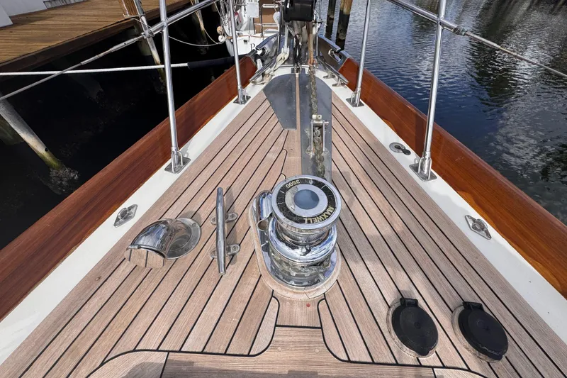 Slide: The Image of 1989 Little Harbor Sloop 58' docked, showcasing teak deck and polished fittings. - 38