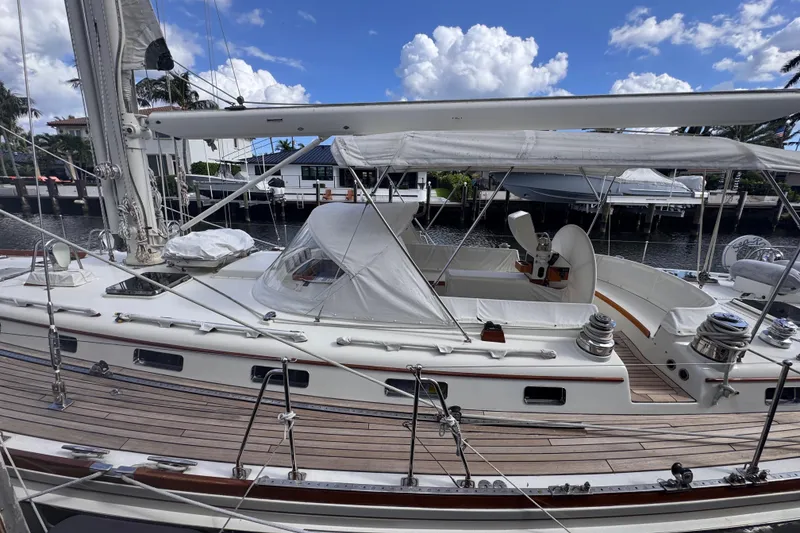 Slide: The Image of 1989 Little Harbor Sloop 58' sailboat docked, featuring sleek design and spacious deck. - 5