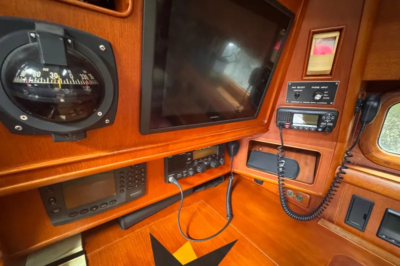 Slide: The Image of Navigation equipment on 1989 Little Harbor Sloop 58' yacht, featuring compass and communication devices. - 65