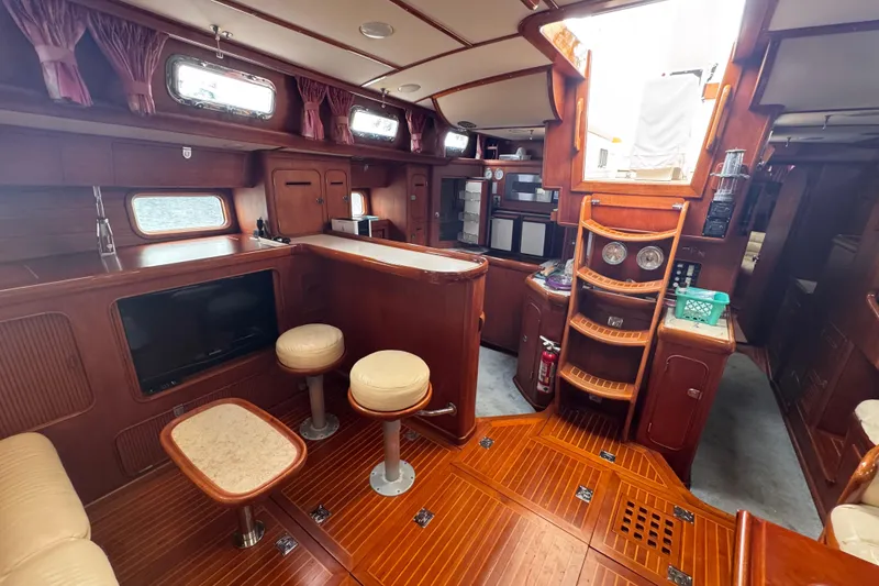 Slide: The Image of Luxurious 1989 Little Harbor Sloop 58' interior with elegant wood finish and seating area. - 80