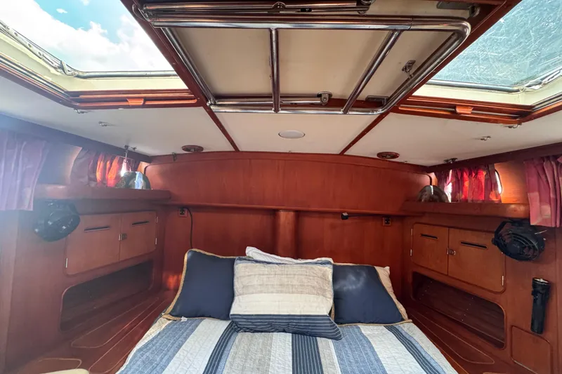 Slide: The Image of Cozy cabin interior of 1989 Little Harbor Sloop 58', featuring wood paneling and skylights. - 86