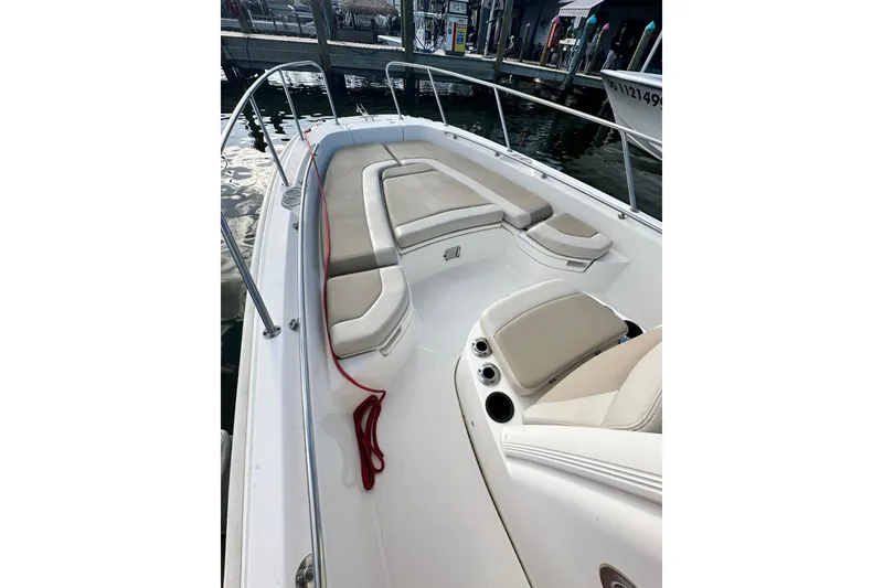 Slide: The Image of 2018 Boston Whaler Dauntless 240 boat interior with cushioned seating and red rope. - 1