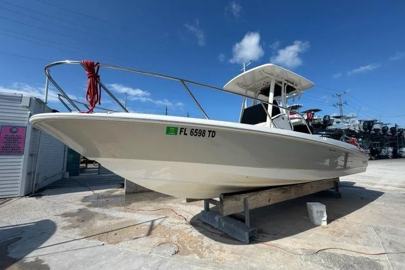 Slide: The Image of 2018 Boston Whaler Dauntless 240 boat on dry dock under clear blue sky. - 14