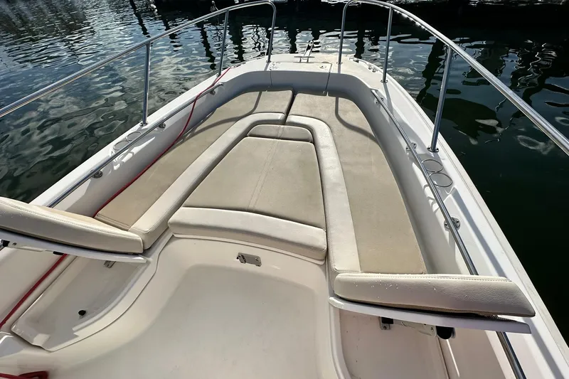 Slide: The Image of 2018 Boston Whaler Dauntless 240 boat with cushioned seating and stainless steel railings. - 2