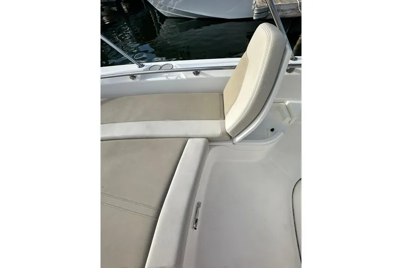 Slide: The Image of 2018 Boston Whaler Dauntless 240 boat interior with cushioned seating. - 3