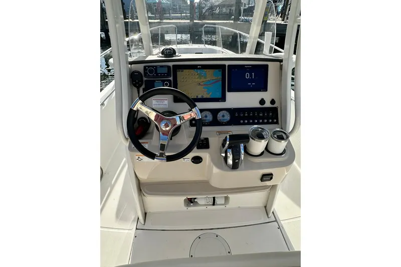 Slide: The Image of 2018 Boston Whaler Dauntless 240 helm with navigation screens and steering wheel. - 6