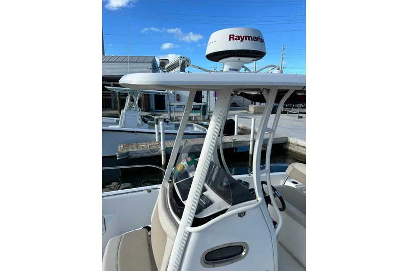 Slide: The Image of 2018 Boston Whaler Dauntless 240 boat with Raymarine radar, docked under clear blue sky. - 9