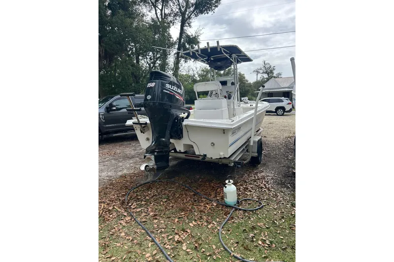 Slide: The Image of 2017 Twin Vee 22 BayCat boat with Suzuki outboard motor in a yard setting. - 4