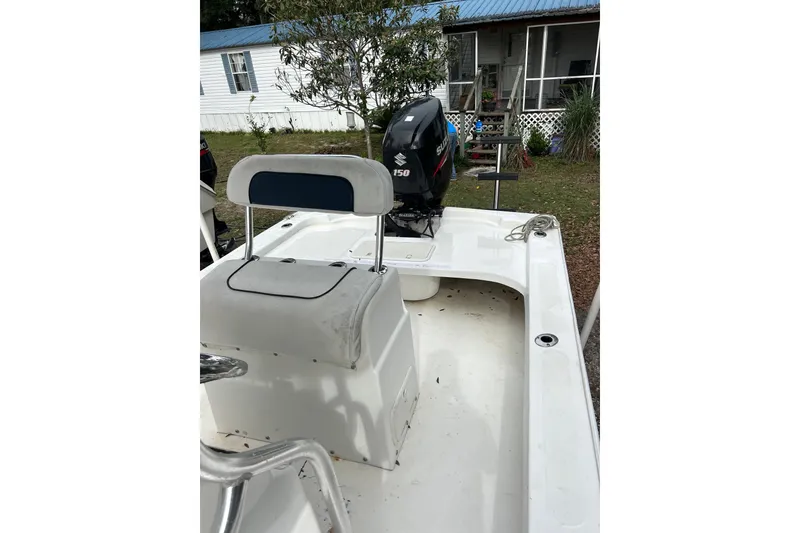 Slide: The Image of 2017 Twin Vee 22 BayCat boat with Suzuki outboard motor, parked near a house. - 7