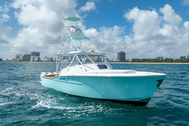 The Image of 2025 Rybovich Custom Margaritavich yacht cruising on ocean near city skyline. - 0