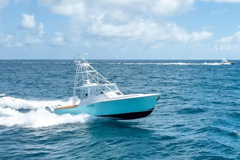 Slide: The Image of 2025 Rybovich Custom Margaritavich yacht cruising on open ocean under blue sky. - 1