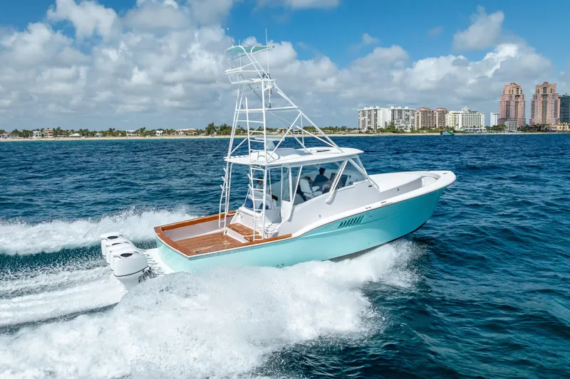 Slide: The Image of 2025 Rybovich Custom Margaritavich boat cruising on ocean near city skyline. - 12