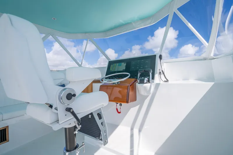 Slide: The Image of Helm of Custom Margaritavich 2025 yacht with modern controls and white captain's chair. - 16