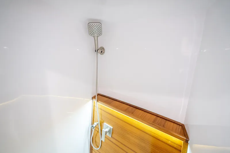Slide: The Image of Modern shower area in 2025 Rybovich Custom Margaritavich yacht, featuring sleek design and wood accents. - 31