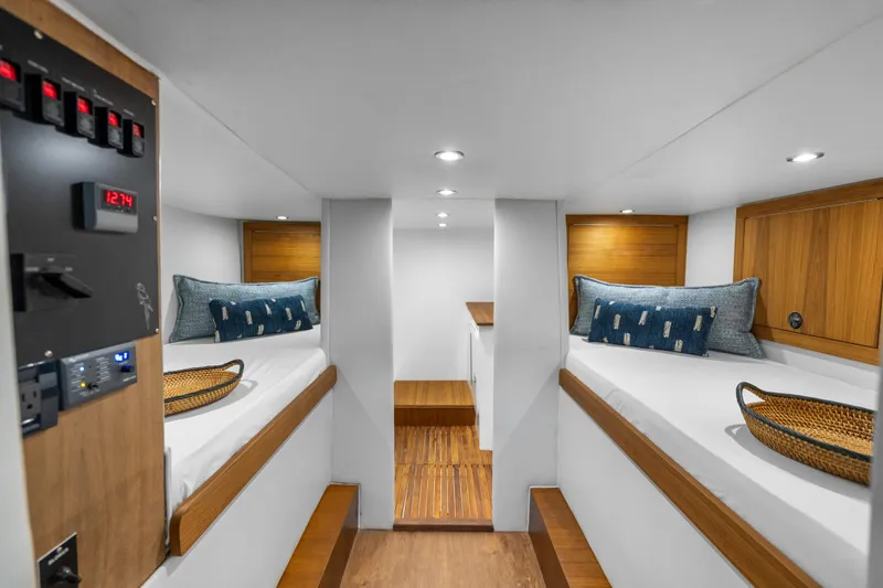 Slide: The Image of 2025 Rybovich Custom Margaritavich yacht interior with twin beds and wooden accents. - 32