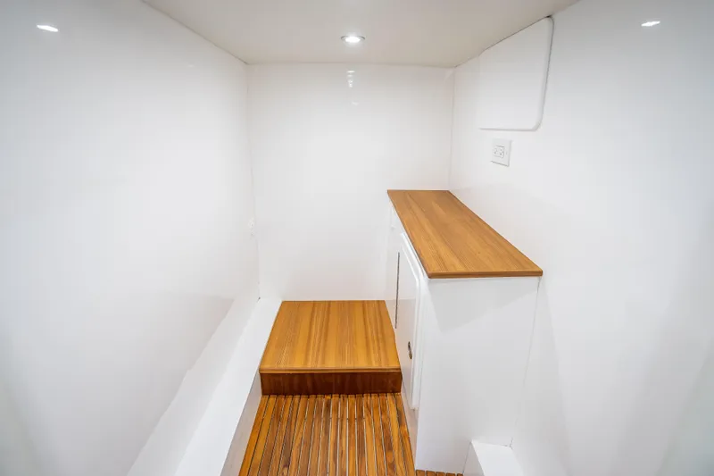 Slide: The Image of Interior of 2025 Rybovich Custom Margaritavich boat with sleek wood accents. - 34