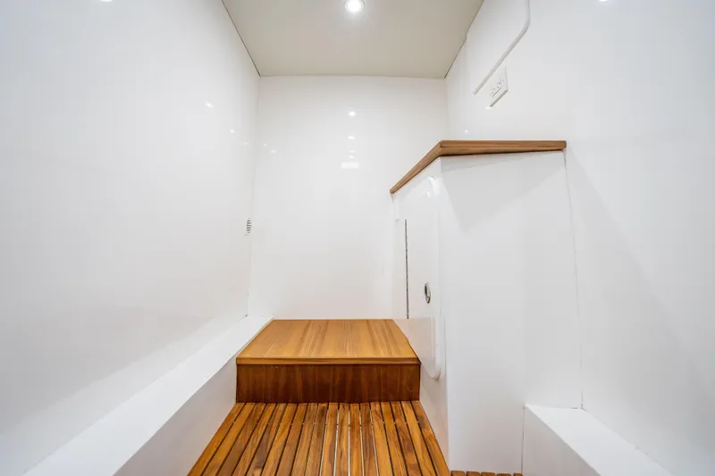 Slide: The Image of Interior of 2025 Rybovich Custom Margaritavich yacht with sleek white walls and wooden flooring. - 35