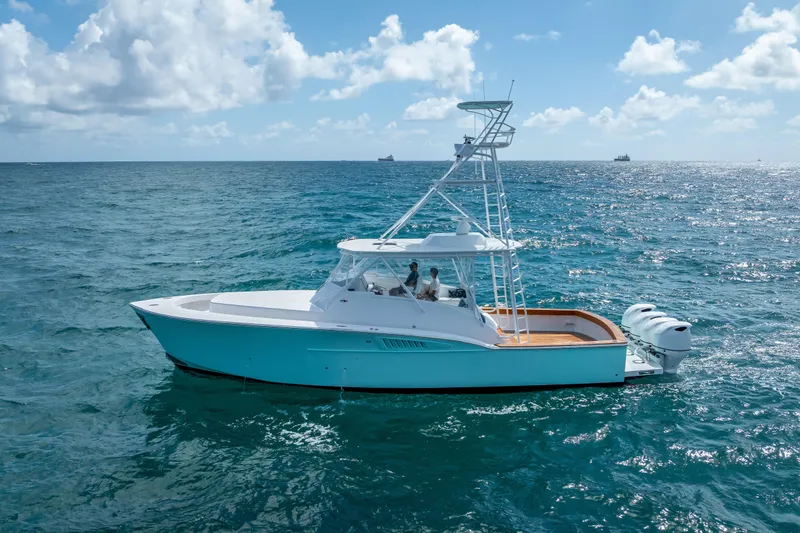 Slide: The Image of 2025 Rybovich Custom Margaritavich yacht cruising on open ocean under blue sky. - 4