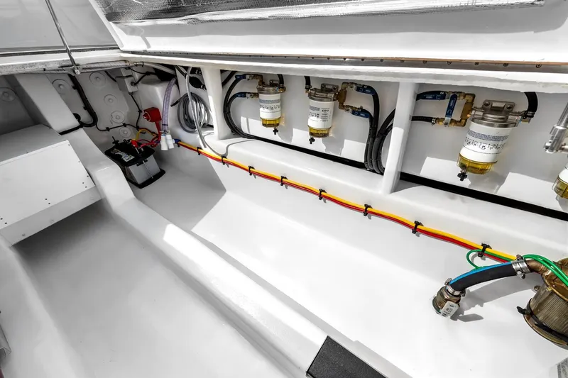 Slide: The Image of Engine compartment of 2025 Rybovich Custom Margaritavich boat, showcasing fuel filters and wiring. - 49