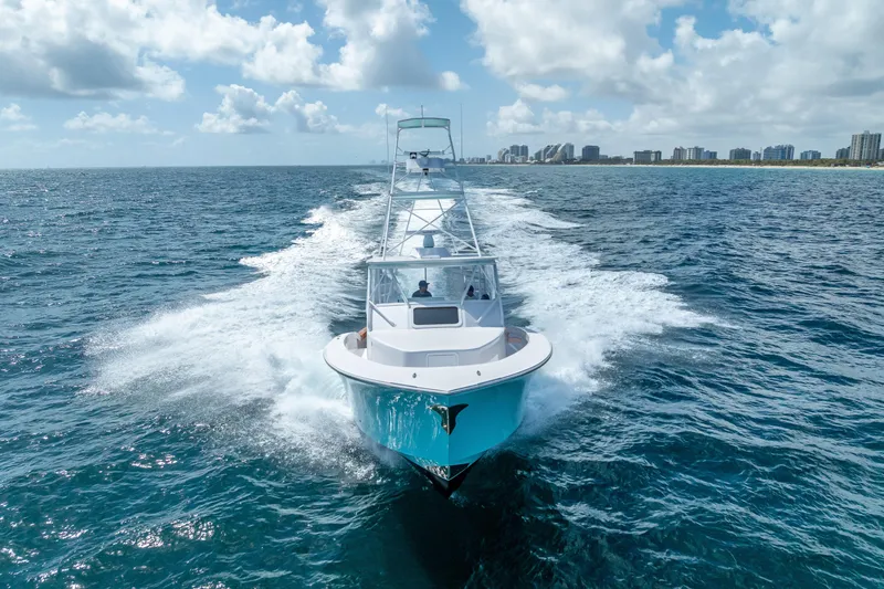 Slide: The Image of 2025 Rybovich Custom Margaritavich yacht cruising on open ocean under blue sky. - 53