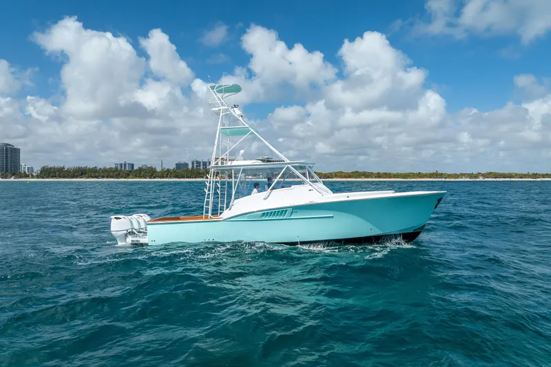 Slide: The Image of 2025 Rybovich Custom Margaritavich yacht cruising on open ocean under blue sky. - 6