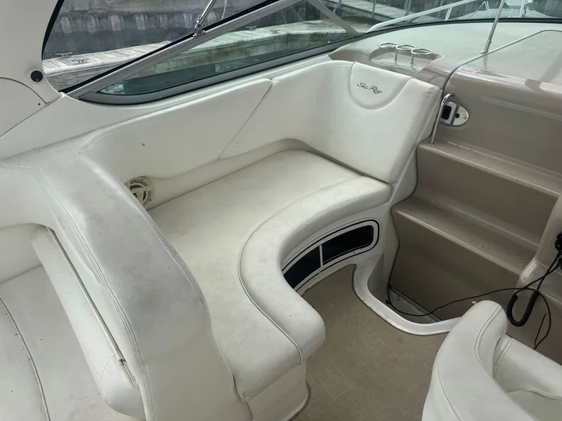 Slide: The Image of The image shows the interior of a 2005 Sea Ray Sundancer 280 with white seating. - 3
