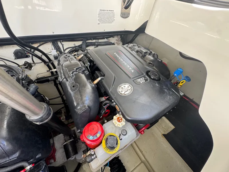 Slide: The Image of The engine compartment of a 2005 Sea Ray Sundancer 280 shows a well-maintained engine. - 11