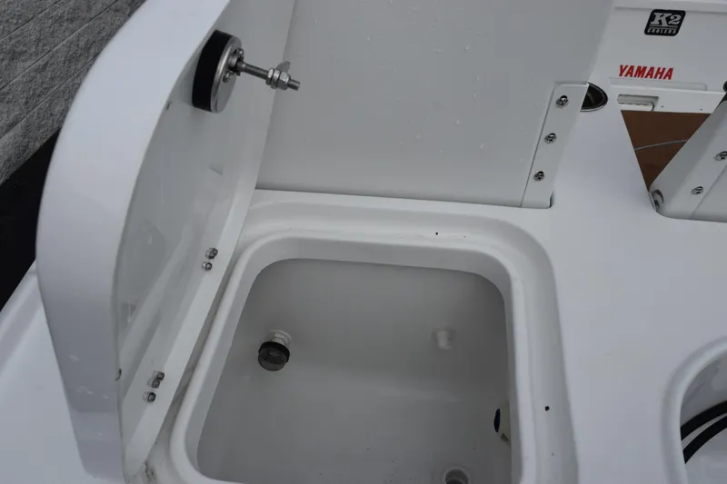 Slide: The Image of 2026 Sea Hunt BX 22 BR boat interior with open storage compartment and Yamaha branding. - 13
